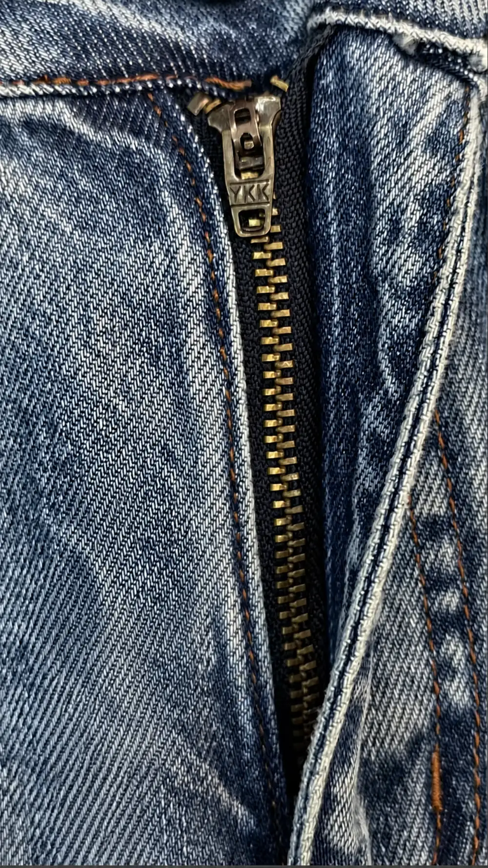 Close view of jeans zipper, fly construction, seams and topstitching