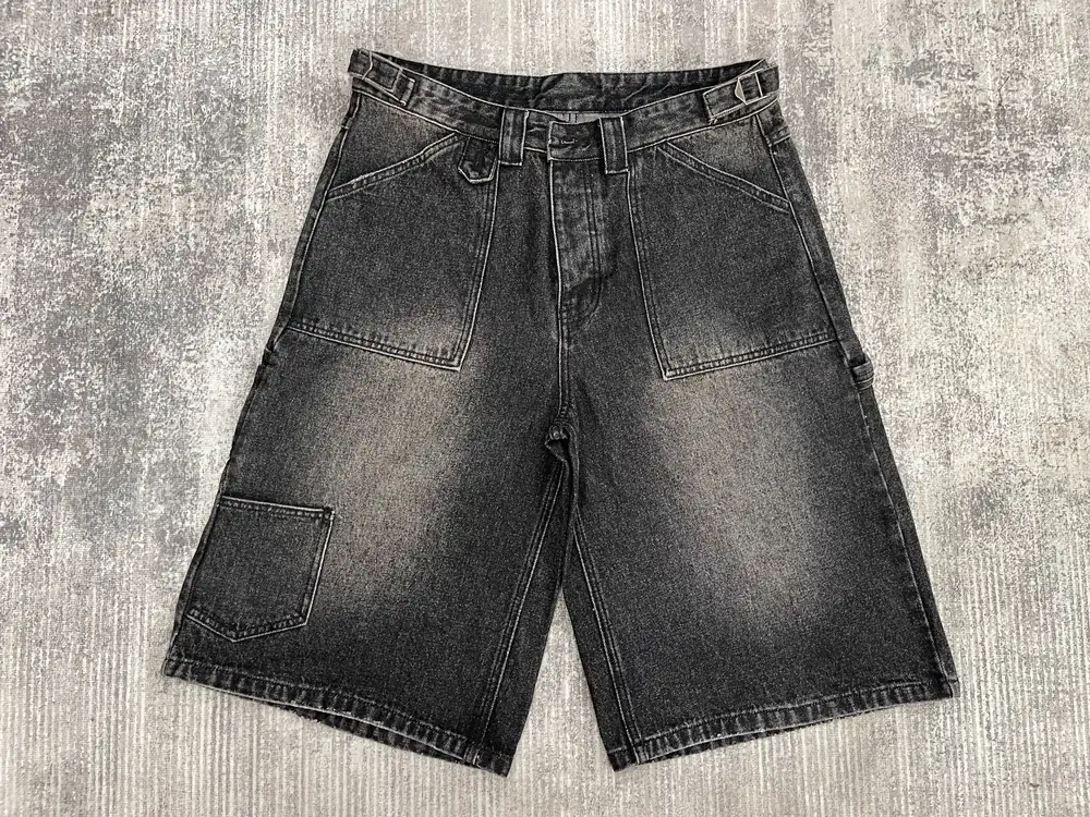 Washed black denim shorts with utility pockets and waistband adjusters