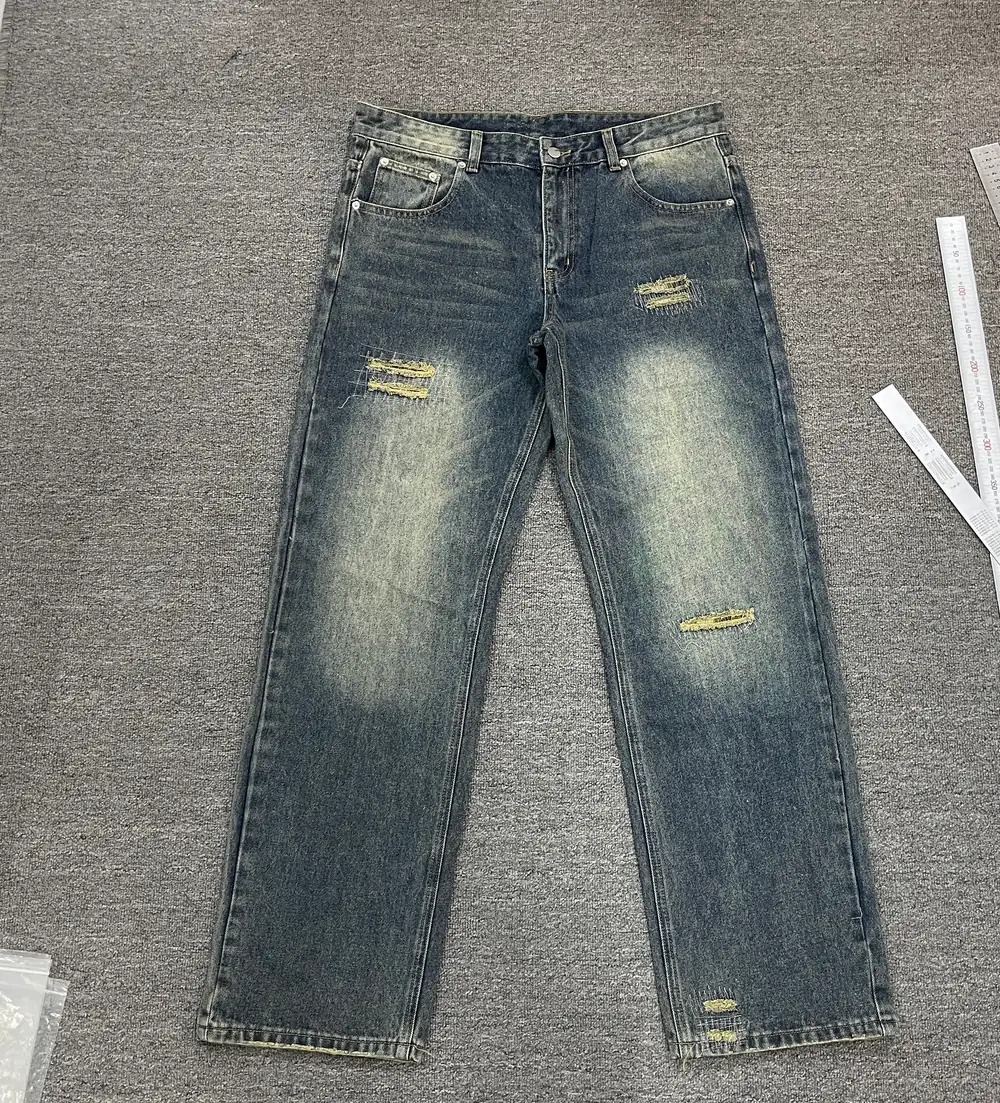 Washed custom jeans sample laid flat for fit and finishing review