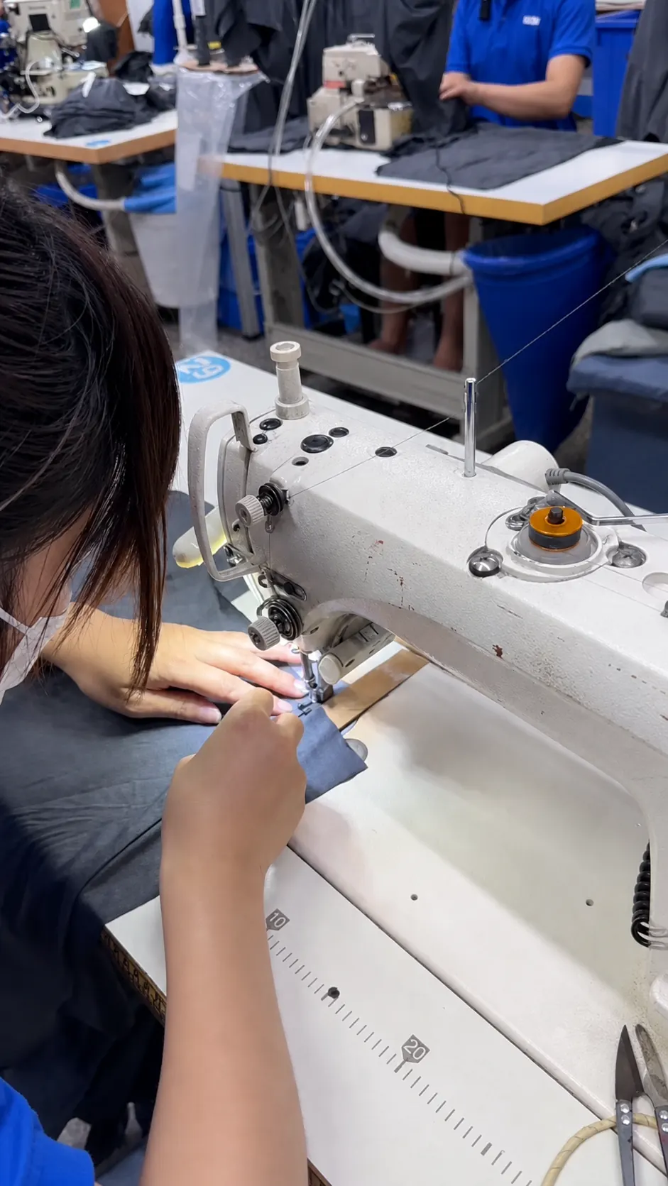 Sewing operator assembling a garment in the DRIOV production environment