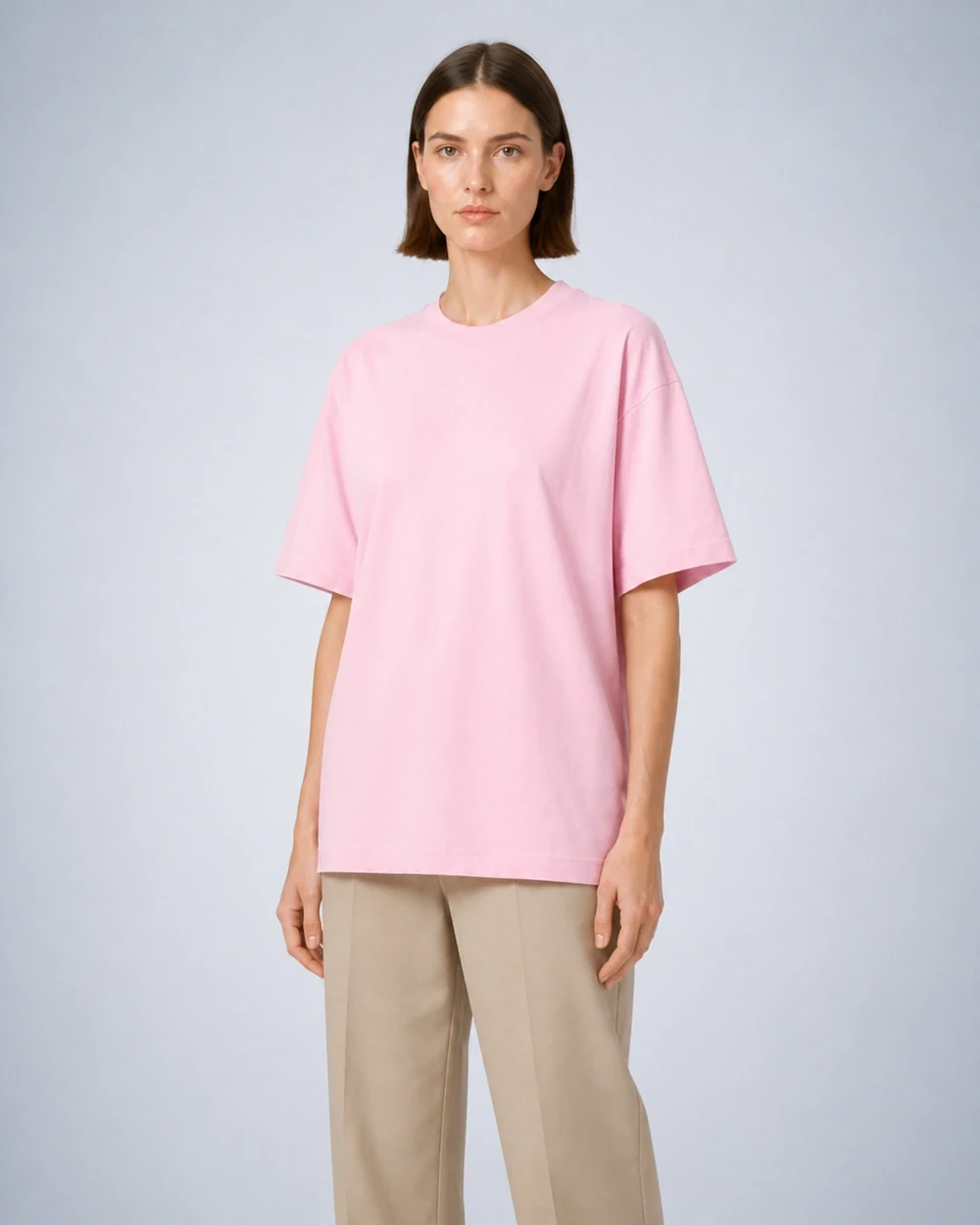 Driov Inspire Tee shown in a mid-length three-quarter model view in Light Pink
