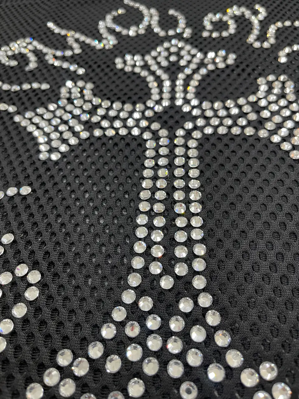 Hot-fix rhinestones applied to compatible apparel fabric