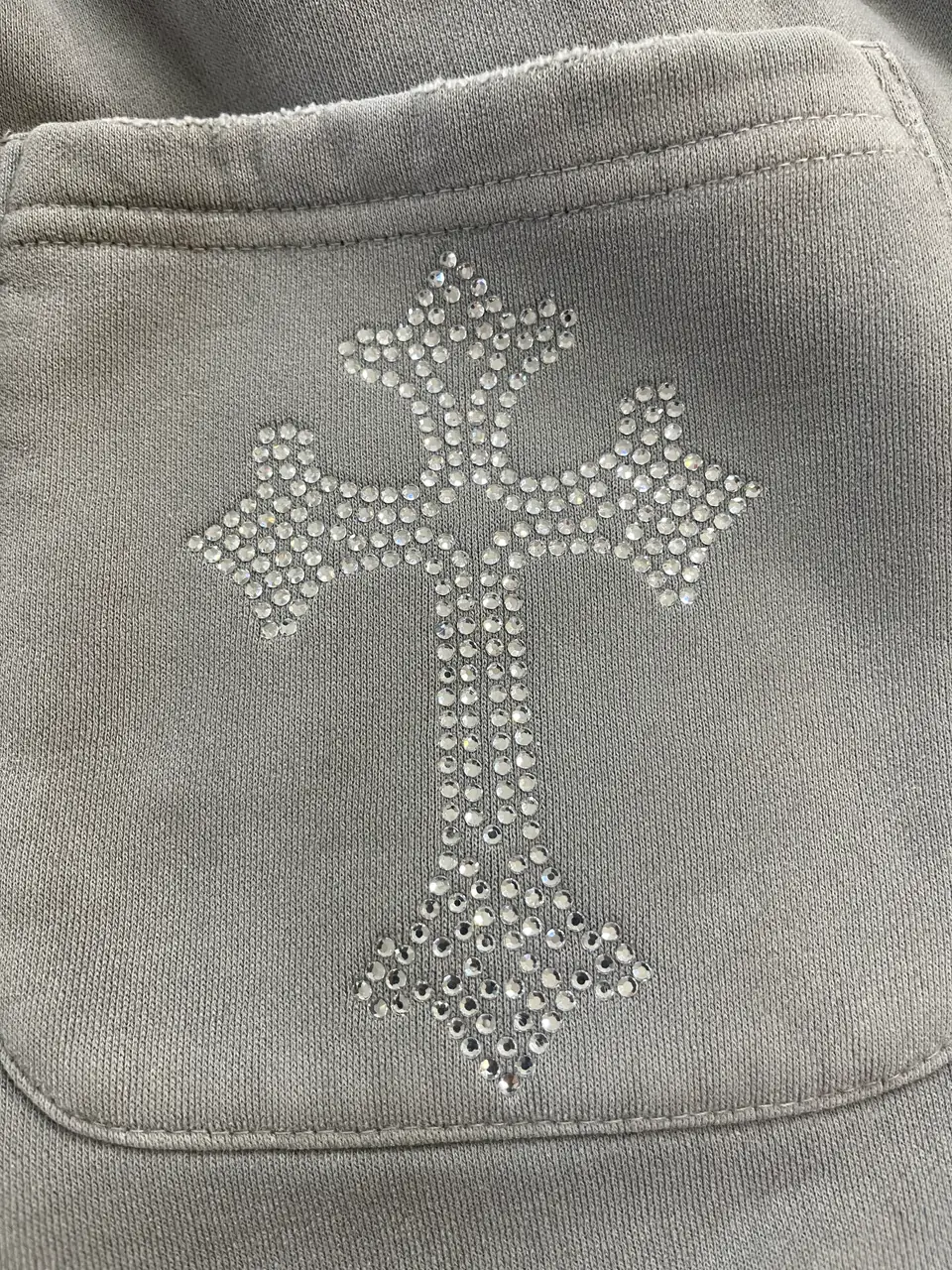 Finished hot-fix rhinestone detail inspected on apparel